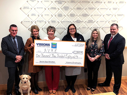 Visions FCU staff presenting a $1,380 Denim Days donation to the staff (and service dog!) of the Association for Vision Rehabilitation and Employment (AVRE).
