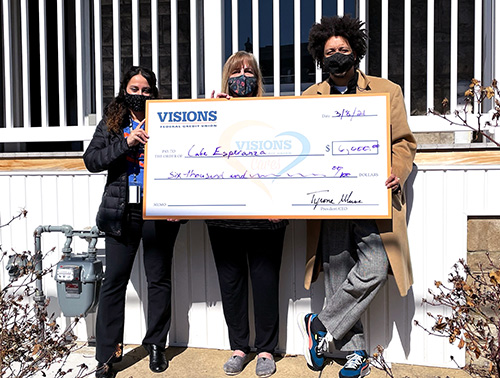 Owners of the pay-what-you-can café, Café Esperanza, are pictured receiving a grant from Visions to expand their efforts within the Reading, PA area.