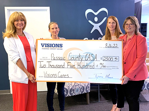 Visions Community Development Liaison for NJ, Shari, presents representatives of CASA (Court Appointed Special Advocates) with a jumbo check to support of their 15th Anniversary Gala.