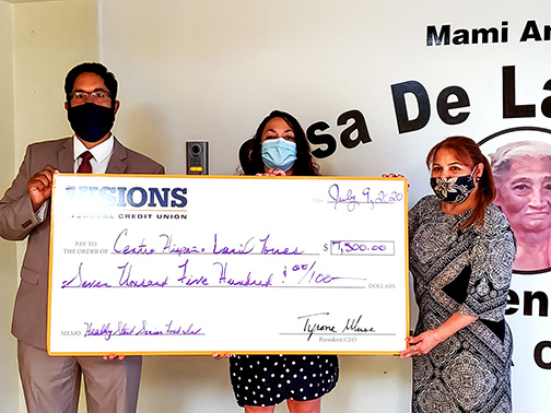 Centro Hispano staff pose with Visions employee during a check presentation as they accept a grant to support their novel breakfast program for senior citizens.