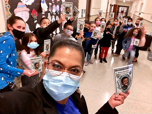 A group of elementary school kids show off their copies of “Danny Dollar Millionaire Extraordinaire” by Ty Allan Jackson.