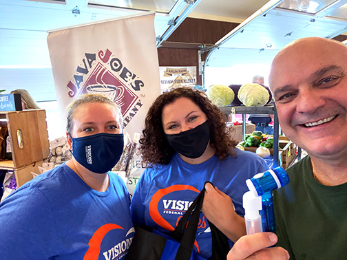 Visions employees Lindsay and Jocelyn pose with Vice President of Java Joe's coffee shop, Eric, at the Broome County Regional Farmers Market.