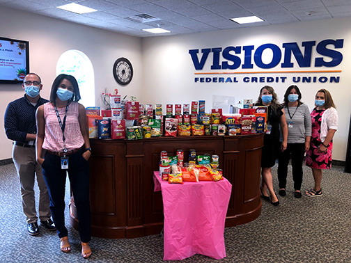 Employees of our Hackettstown, NJ office show off their food donations for the Visions Corporate Give Back Challenge.