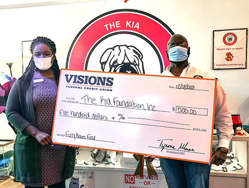 Sam and Kate, co-founders of The Kia Foundation, are pictured with a giant check in support of their Furry Kisses Fund!