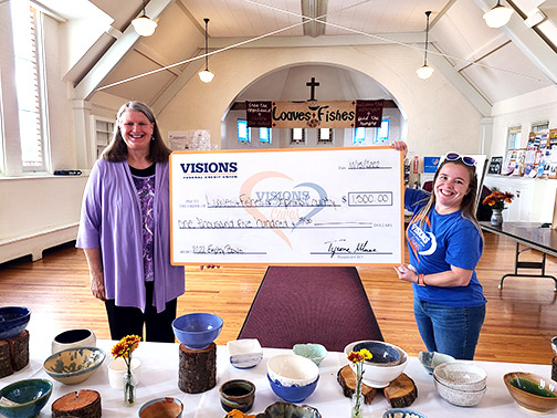 Pictured accepting a giant sponsorship check from our Community Development Liaison, Sarah Parton, is Christina Culver, Executive Director of Loaves & Fishes of Tompkins County.