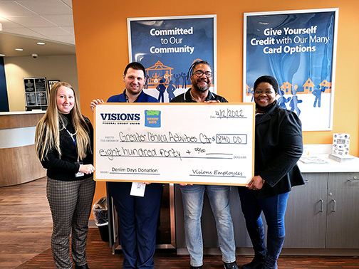 At our Ithaca office, Visions Member Account Specialist, Courtney Hazen, and Branch Manager, Eric Gergel, present a jumbo Denim Days check to the directors of Greater Ithaca Activities Center.