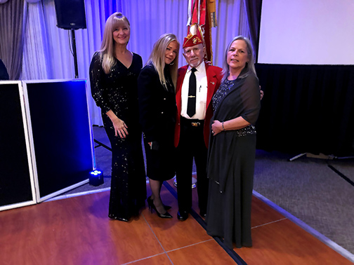 Visions Board Member, Laurie Schorno, and her husband, Hector Schorno, who is also the Marine Corps League Chaplain, pose with Business Development Officer, Liz McDonough, and Community Development Liaison, Shari Leone at the Marine Corps Ball at Crystal Springs Resort in Vernon, NJ.