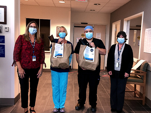 Employees Mary and Gloria from our New Jersey offices, donate meals and goodie bags to Emergency Room Nurses at Atlantic Health System's Newton Medical Center.