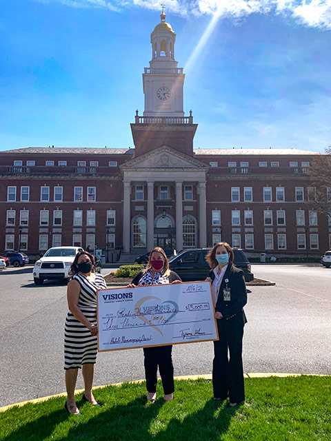 Pictured is Director of Impact and Engagement, Lizette Epps, presenting to the Reading Hospital Foundation with a grant check for the Mobile Mammography Coach.