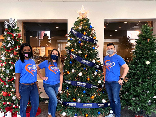 Our Community Development team proudly stands by their newly decorated Visions tree that will display during the annual Roberson Museum and Science Center Home for the Holidays celebration.