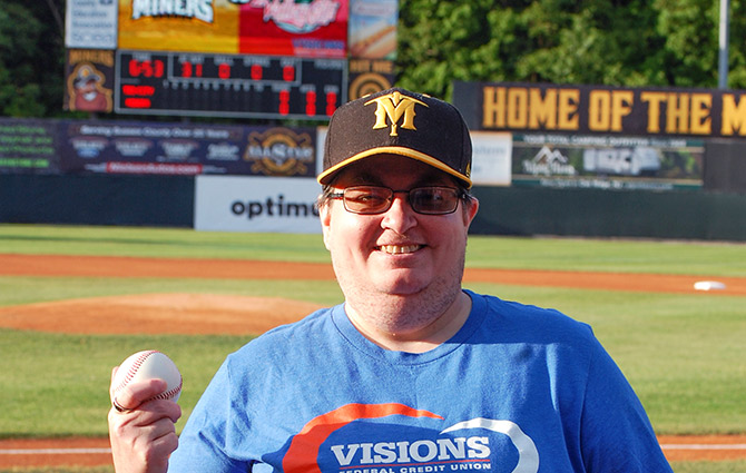 Visions employee Sandi Cerciello smiles while holding the baseball she used to throw the first pitch at a Sussex County Miners baseball game in Augusta, NJ.