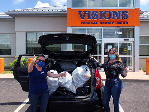 Our Community Development Liaison, Sarah, gives the camera two thumbs up with a Friends Forever Animal Rescue representative as they stand in front of a filled carload of bottles and cans collected by our Syracuse and Cicero offices.