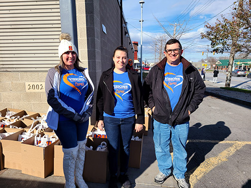 Pictured: Cortny (Risk Mitigation), McKenzie (Risk Mitigation), and John Christopher (Sr. Member Account Specialist - Visions Syracuse Office) with Thanksgiving dinner boxes.