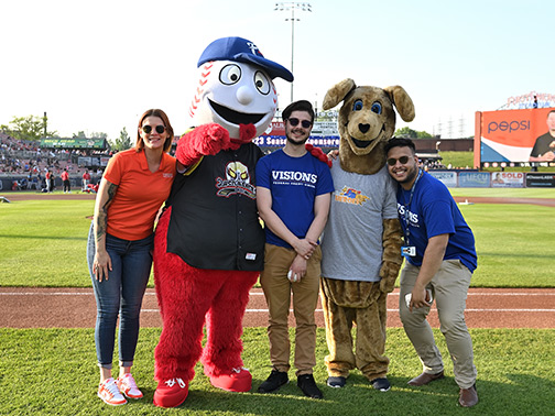 Visions employees Lindsay (left), Jadon (middle), and Gustavo (right) pictured with the Reading Fightin' Phils baseball team mascot and Kirby Kangaroo.