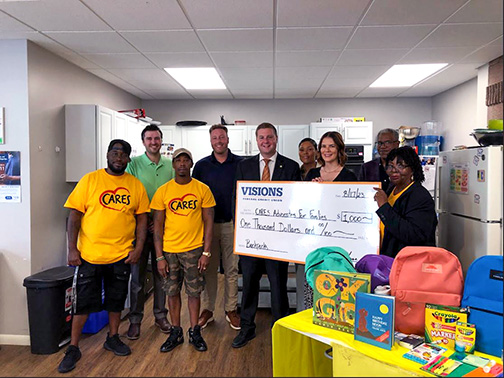 CARES Representatives, Visions representatives, and the City of Binghamton Mayor, Jared Kraham, pictured with a check presented to the CARES Advocates for Families organization. 