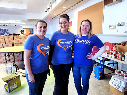 Visions employees McKenzie, Cortny, and Kenda posing for a photo at the ED23 Foundation’s 6th Annual Turkey Dinner Giveaway. 