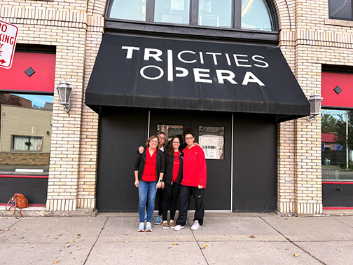 Visions volunteers standing outside the Tri-Cities Opera.