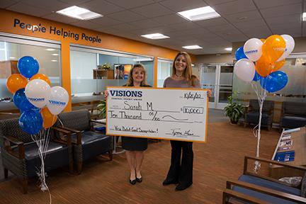 Sarah M. of Endicott, NY holding a giant check for $10,000, along with Deb, our Card Solutions Manager