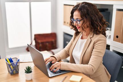 middle aged hispanic woman on laptop