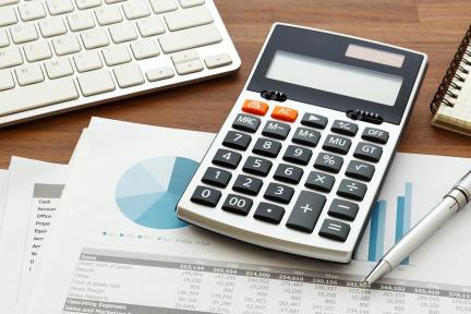 calculator and paperwork on desk