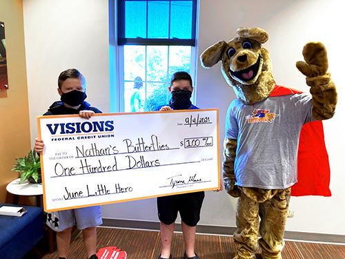 Ben, Preston, and Kirby pictured with a large $100 check donation from Visions to Nathan's Butterflies