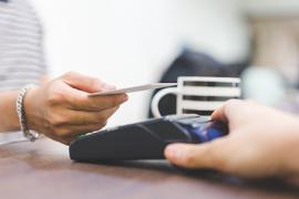 Credit Card being tapped to pay